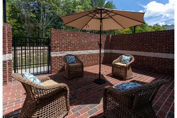 Outdoor seating area with chairs and umbrella