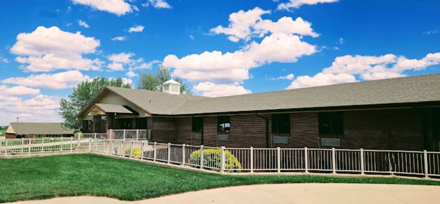 Exterior view of Pleasant View Home with blue sky.