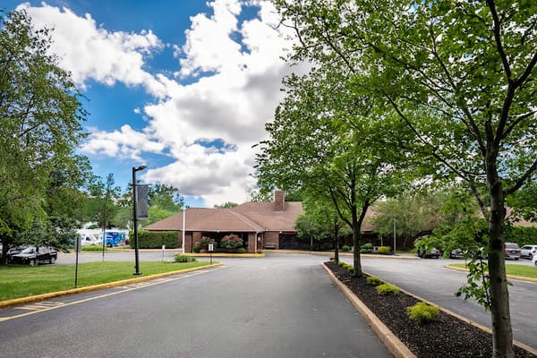 Exterior view of a senior living facility surrounded by greenery
