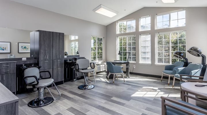 Bright and spacious hair salon with styling chairs and large windows