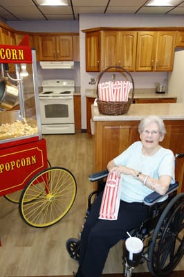 Resident enjoying popcorn in the facility kitchen