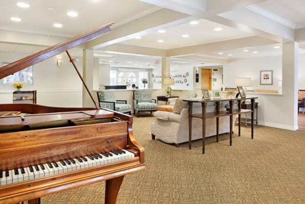 Lounge area with a piano and seating