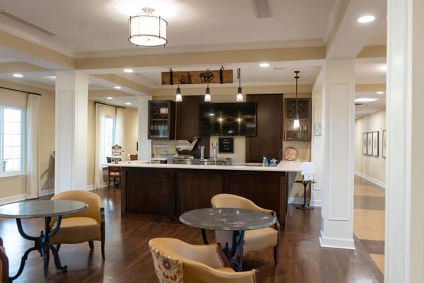 Bright common area with a kitchenette and seating