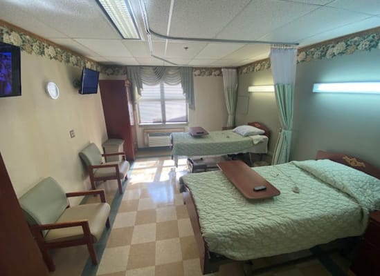 Double occupancy resident room with beds and seating area