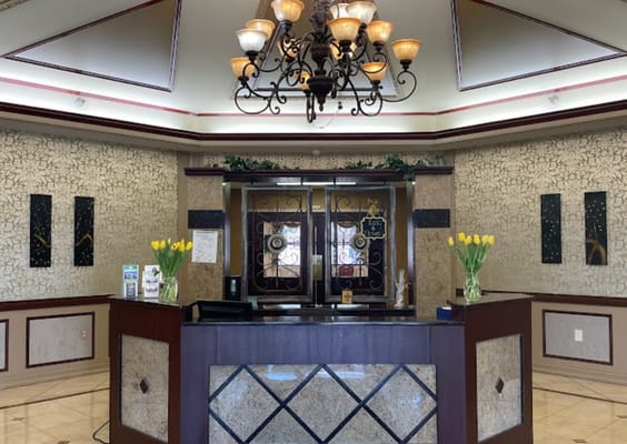 Reception area with chandelier and floral decor