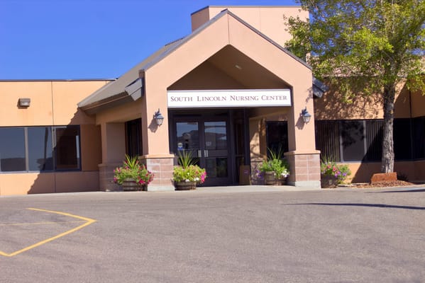 Entrance of South Lincoln Nursing Center with signage and landscaping.