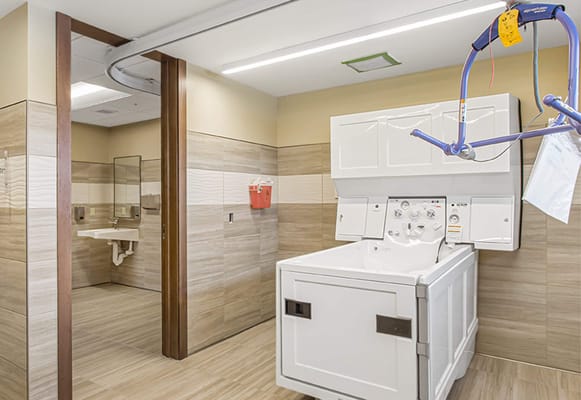 Laundry room with washing machine and support equipment