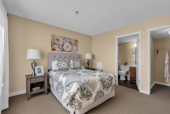 A well-decorated private resident room with a bed and bathroom