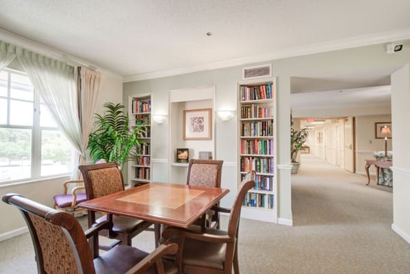 Common area with a table and bookshelves