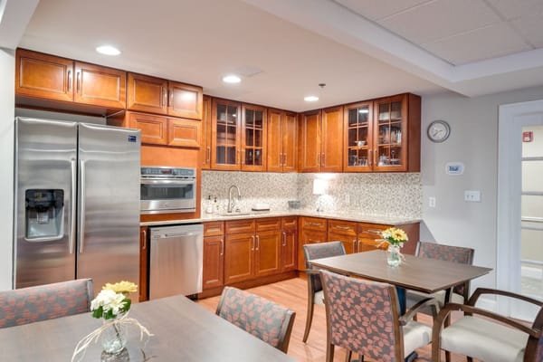 Modern kitchen and dining area with wooden cabinets and tables