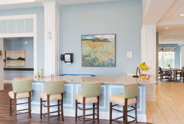 Comfortable lounge area with bar seating and artwork.