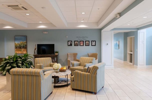 Spacious lounge area with striped chairs and decorative plants