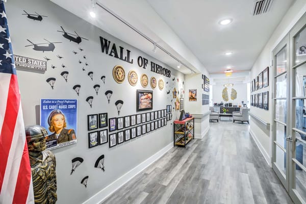 Decorative wall featuring military memorabilia and photos