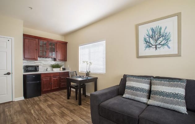Living area with sofa, dining table, and kitchenette