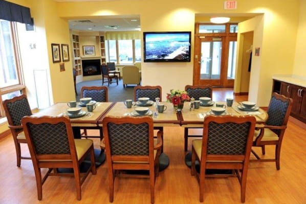 A dining table set for meals in a communal dining area.