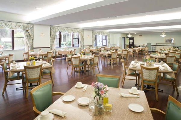 Bright dining room with tables set for a meal