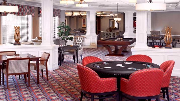 Interior view of the game room with a poker table and comfortable seating.