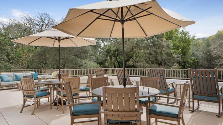 Outdoor patio area with umbrellas and dining furniture