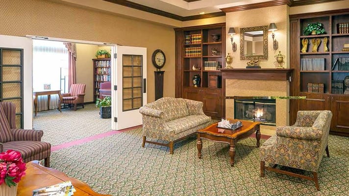 Bright common area with cozy seating near a fireplace