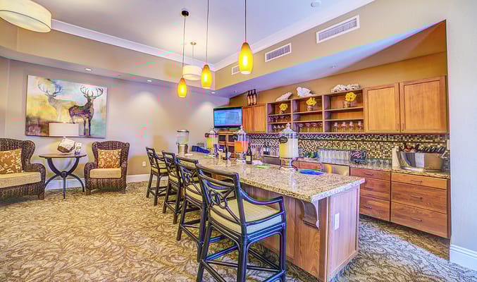 Bright common area with seating and a bar