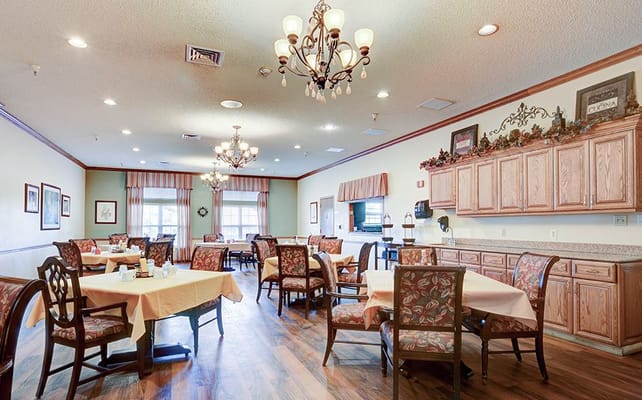 Dining room with tables and chandeliers in a senior living facility