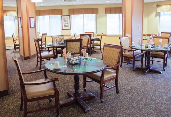 Dining area with tables and chairs in the facility