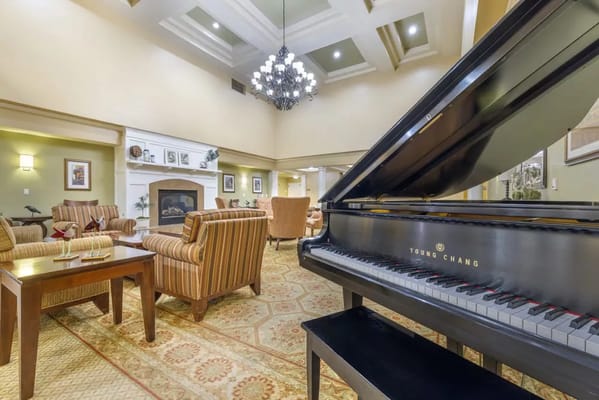 A grand piano in a common area of a senior living facility