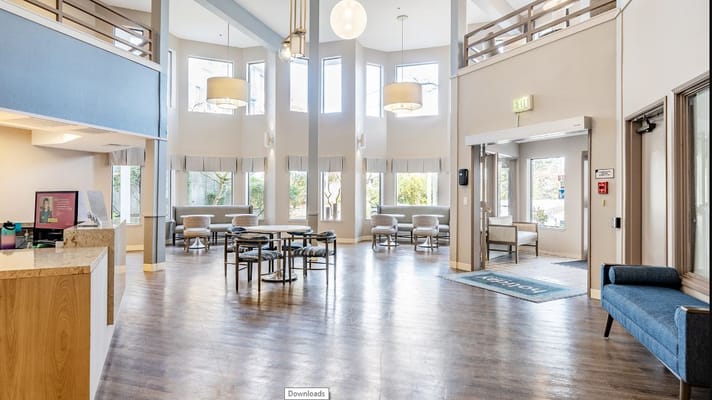 Bright and spacious lobby with seating areas and large windows.