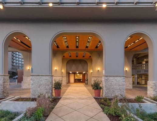 Entrance to an assisted living facility with architecture and landscaping