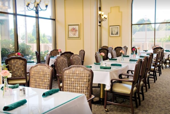 Bright dining area with tables and flowers