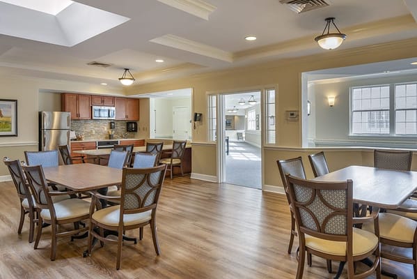 Bright common area with dining tables and kitchenette