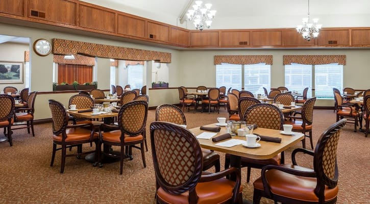 Dining room with tables and chairs set for a meal