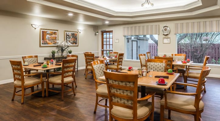 Bright dining room with tables set for meals