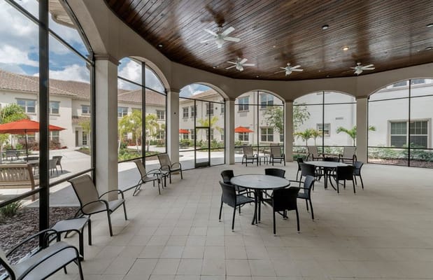 Seating area in a shaded courtyard with tables and chairs