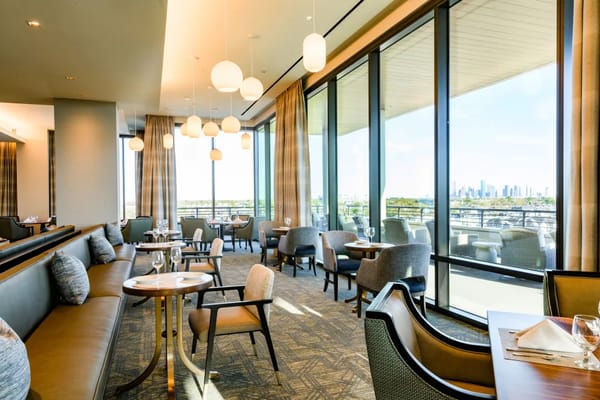 Elegant dining area with large windows and modern decor