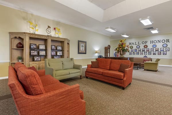Common area with seating and a wall of honor