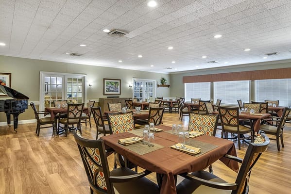 Bright dining room with tables set for meals