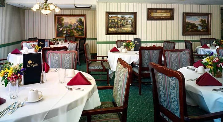 Elegant dining room setup with flowers and table settings
