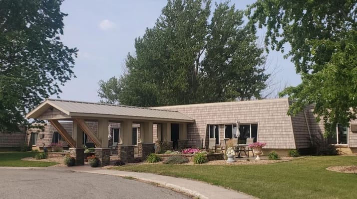 Front view of Dakota Estates with landscaping and seating area