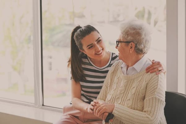 Caregiver interacting with a senior resident indoors