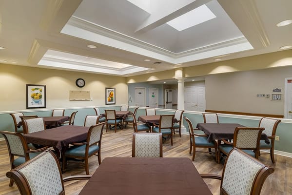 Bright dining room with tables set for meals