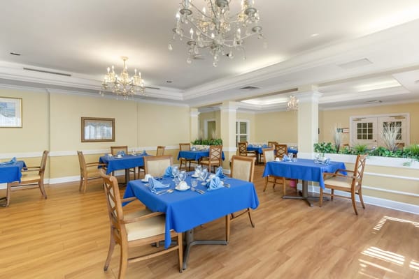 Dining room setup with blue tablecloths and elegant decor