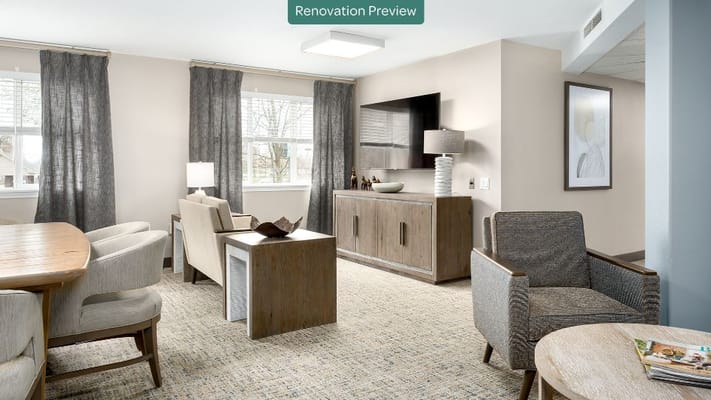 Spacious living room with modern decor and large windows.