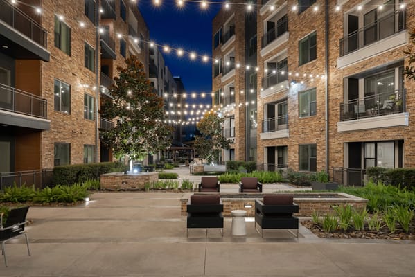 Outdoor courtyard with seating and string lights