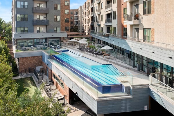 A modern outdoor pool area with lounge chairs