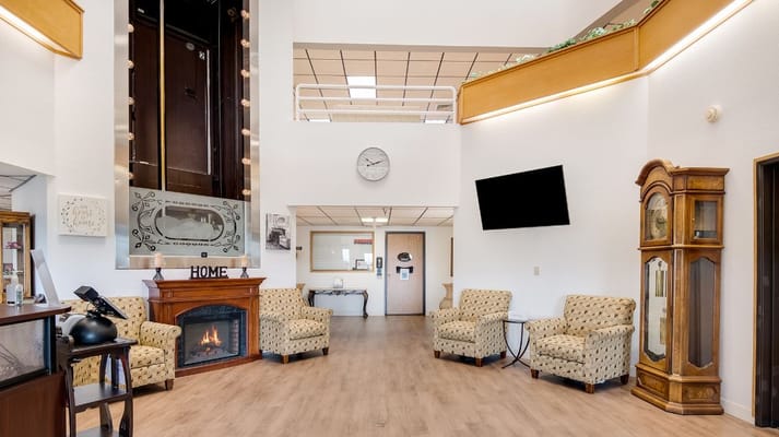 Cozy lobby area featuring seating and a fireplace