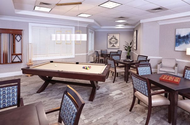 Interior view of the pool table area with tables and chairs