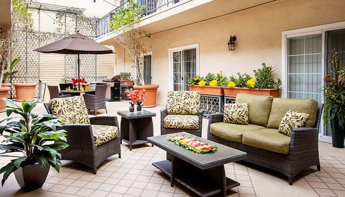 Outdoor seating area with flowers and lounge furniture