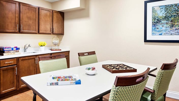 Common area with a game table and kitchenette