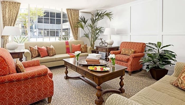 A cozy common area with sofas and fruit display